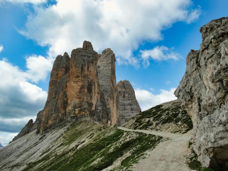 a very tall mountain in the middle of a cloudy sky