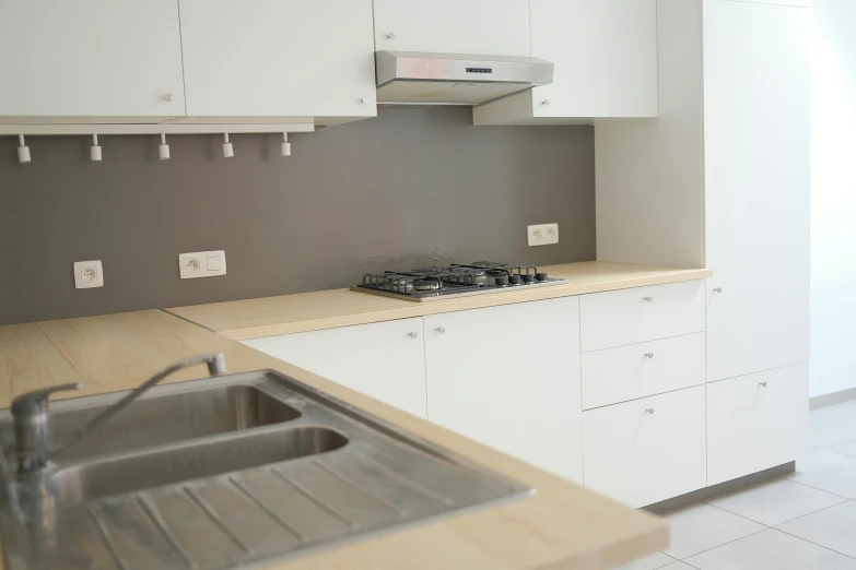 a kitchen with white cabinets and silver appliances