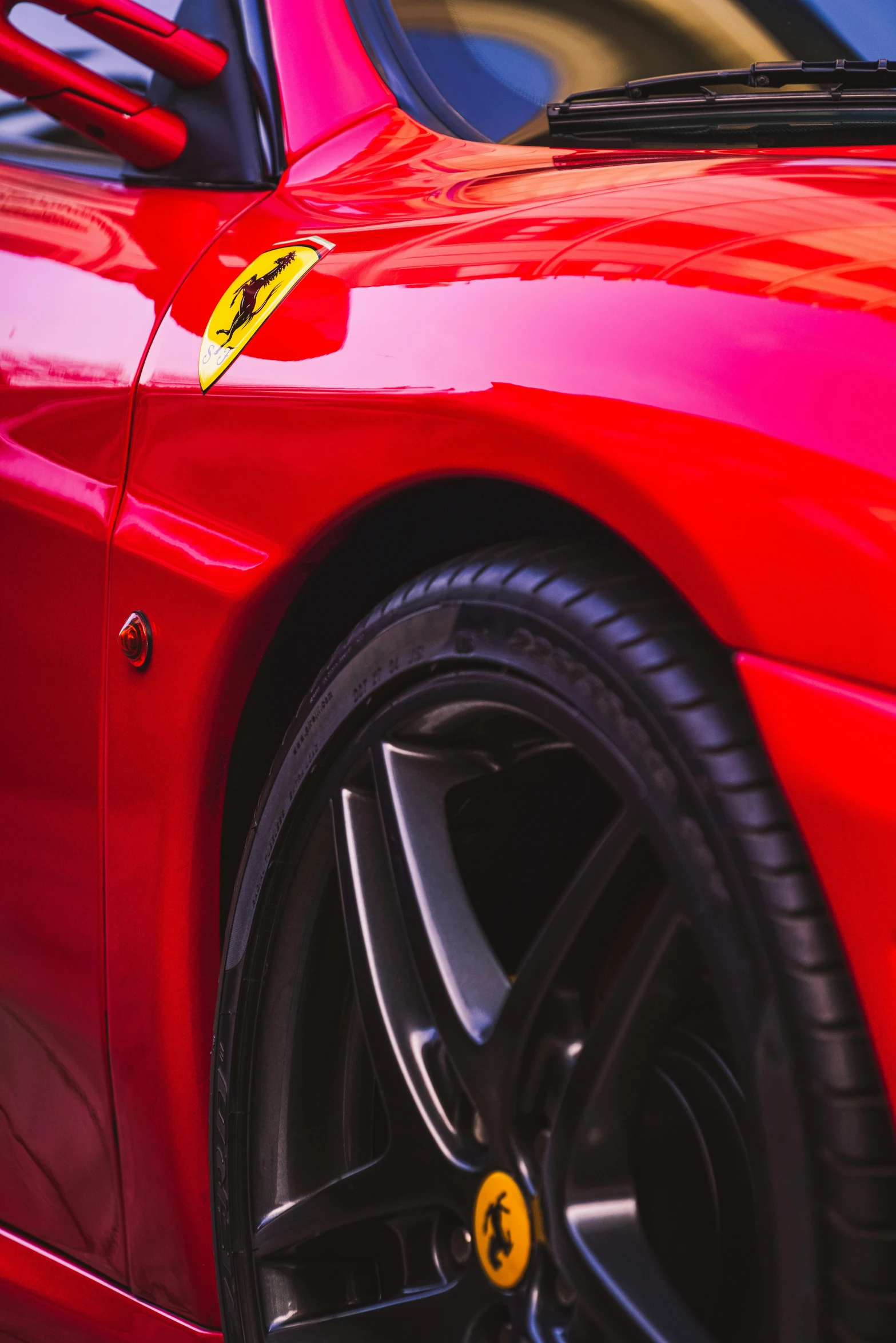 a ferrari sports car sits parked in a lot