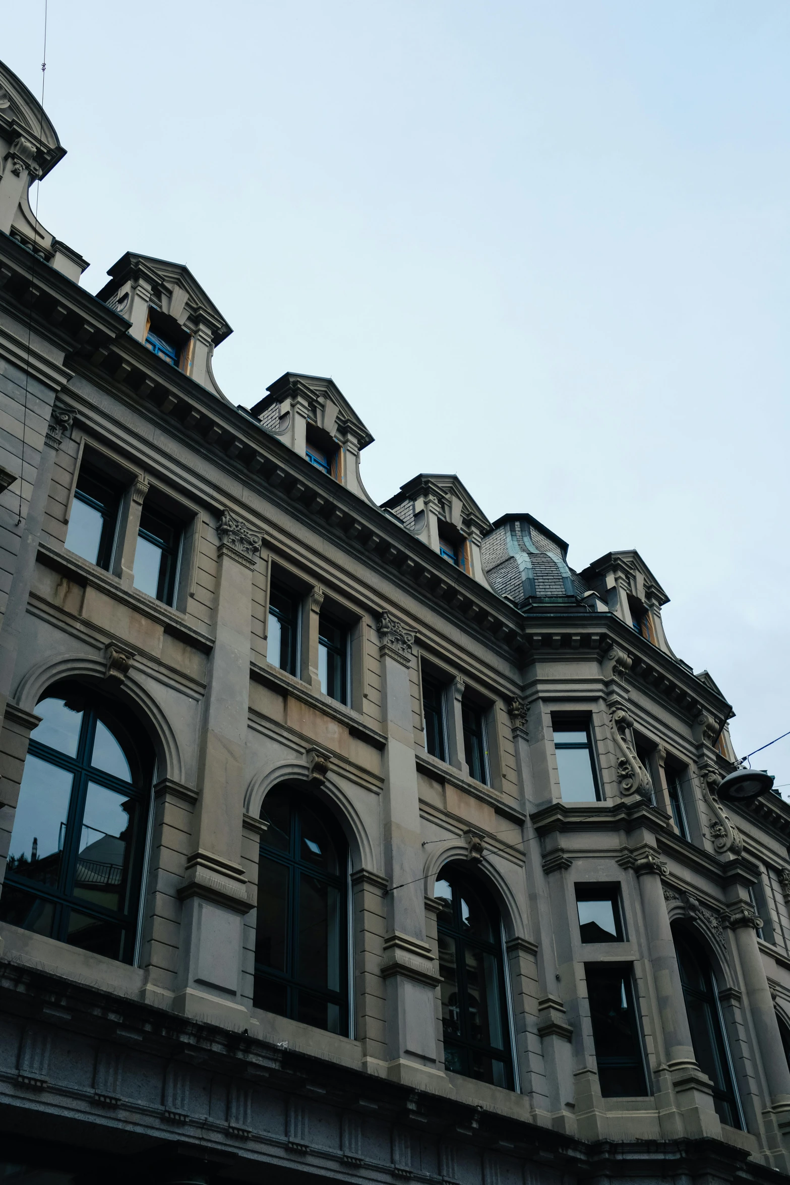 the large building has a clock tower and many windows