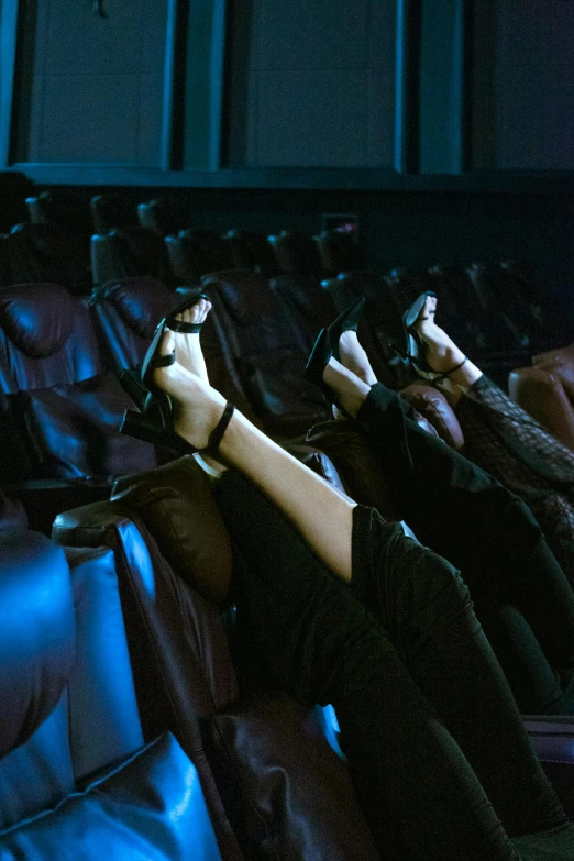 someone is sitting in an empty theater in the evening