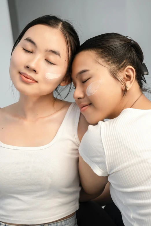 two women with their eyes closed are posing for a picture