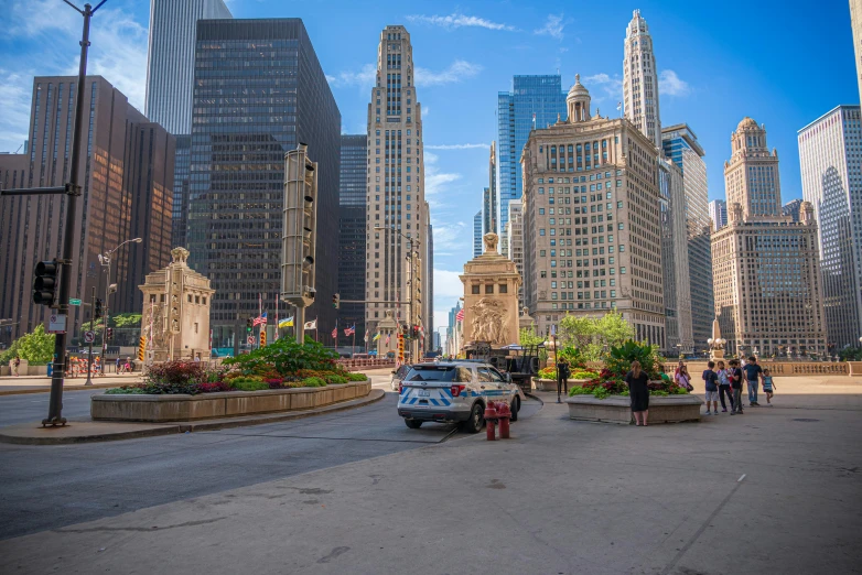 many people walking around with tall buildings in the background