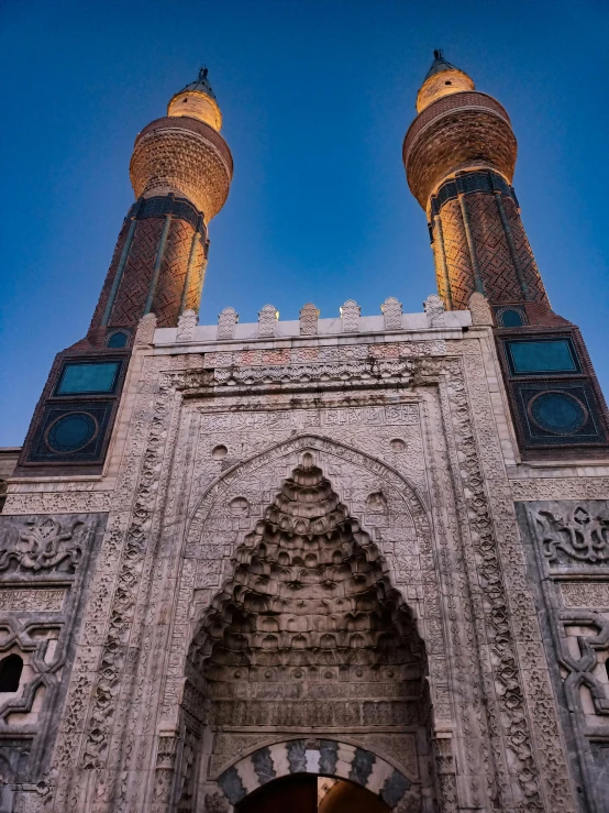 a large stone gate with two towers in it