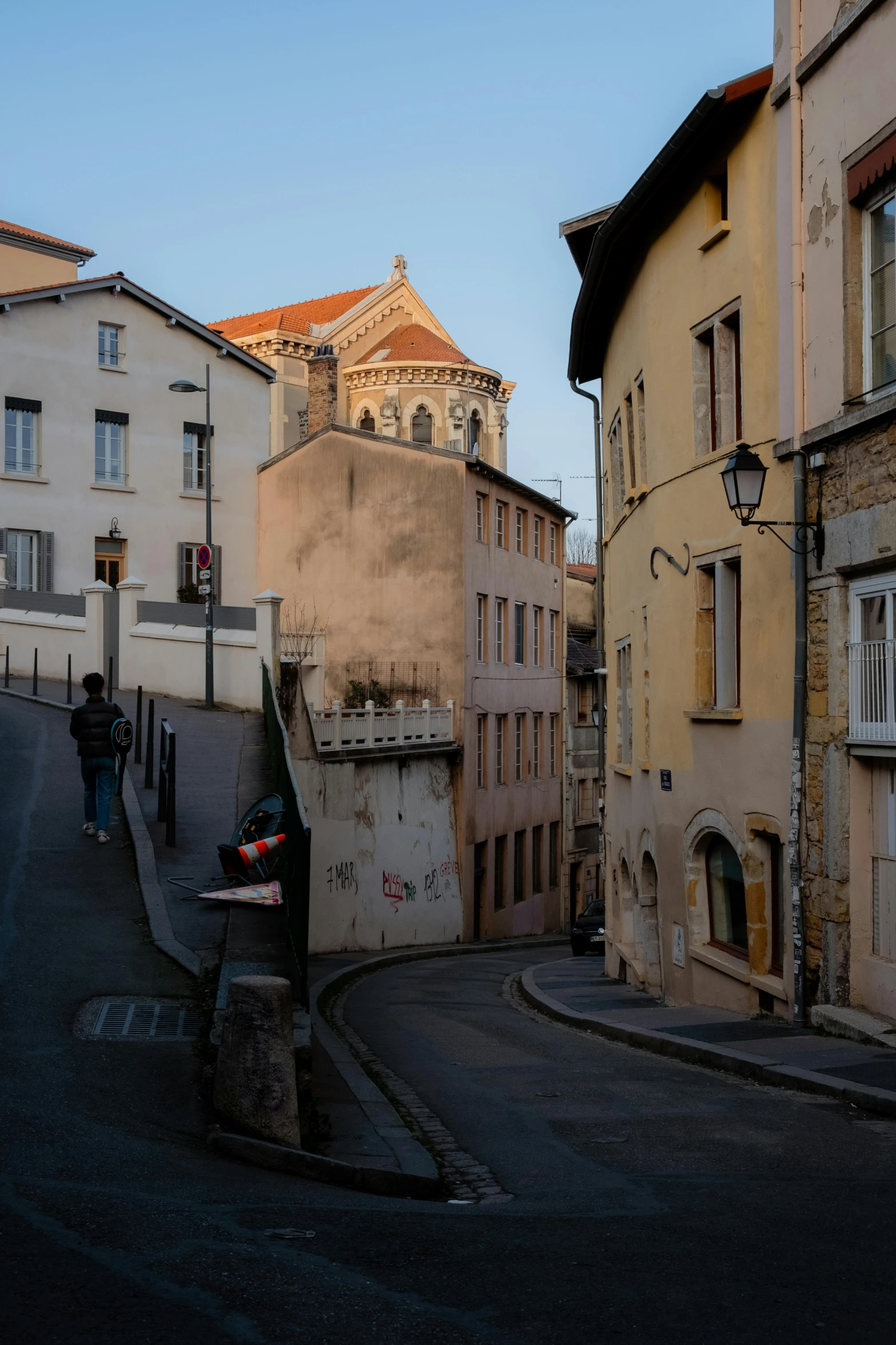 an old street in a small town next to a tall building