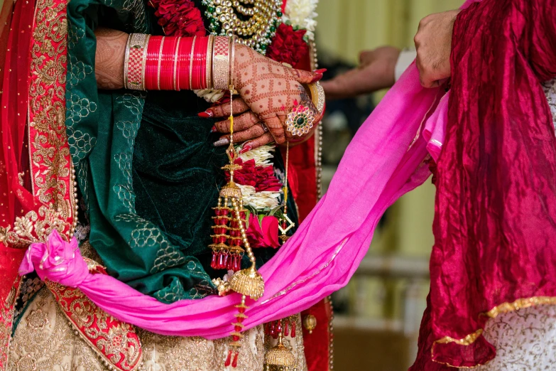 a wedding couple is holding each other's hand