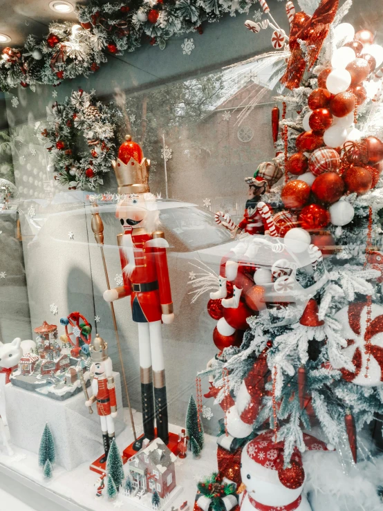 a christmas display with fake soldiers, gifts and trees