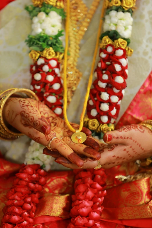 closeup of a woman's hands holding wedding rings and jewelry