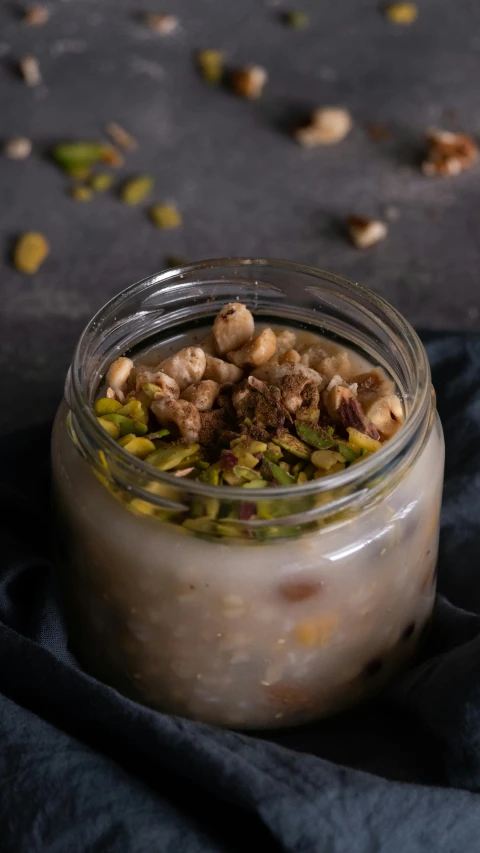 a jar full of food sitting on top of a table