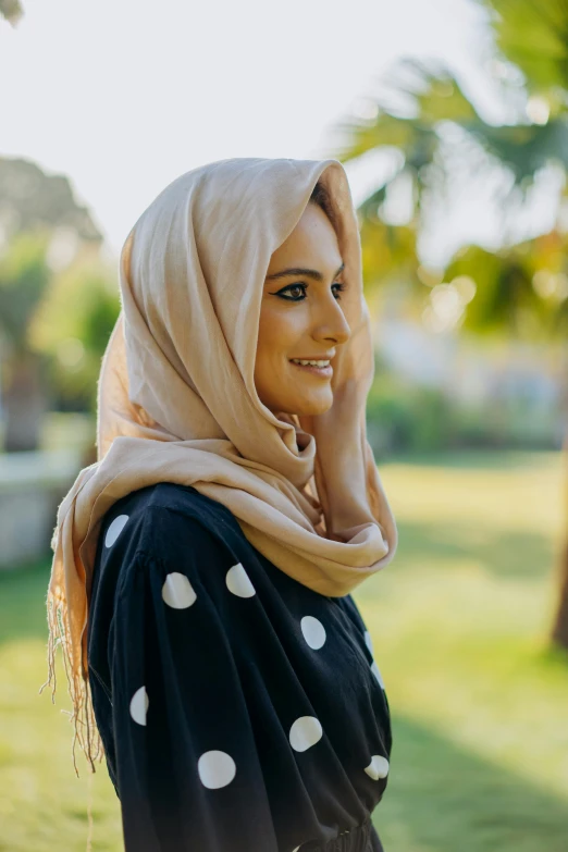 a woman smiling with her hand on her cheek