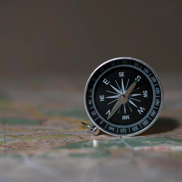 a compass sitting on top of a map