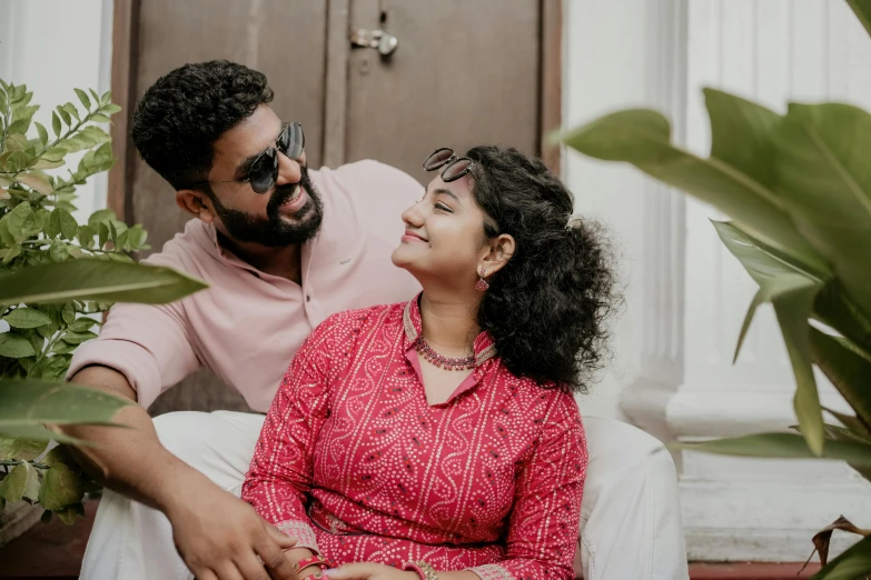 a smiling man and woman sitting side by side