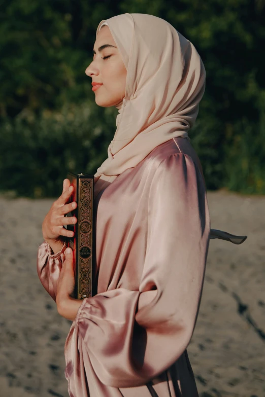 a woman with head scar standing in the sand