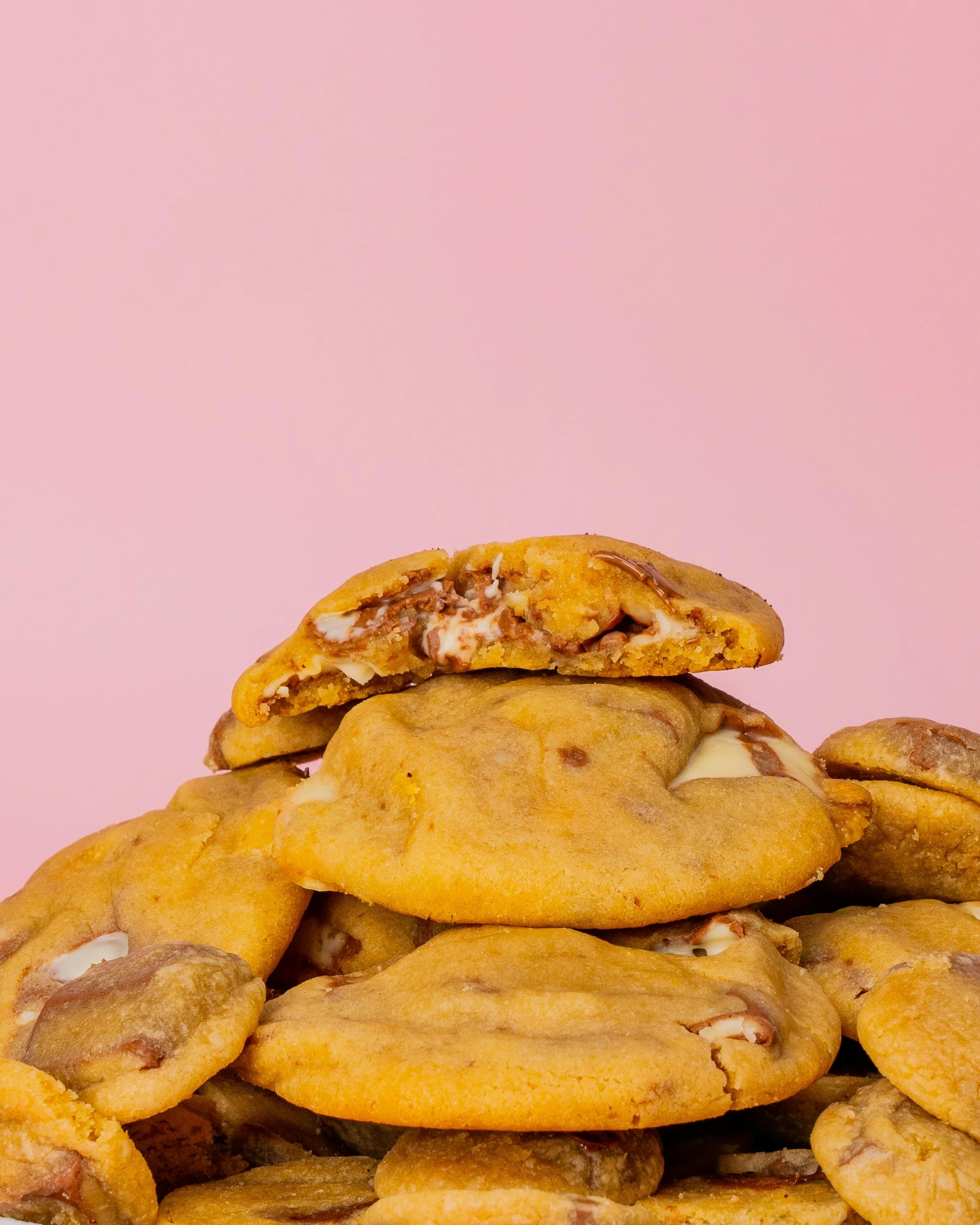 a pile of cookies with cheese on top