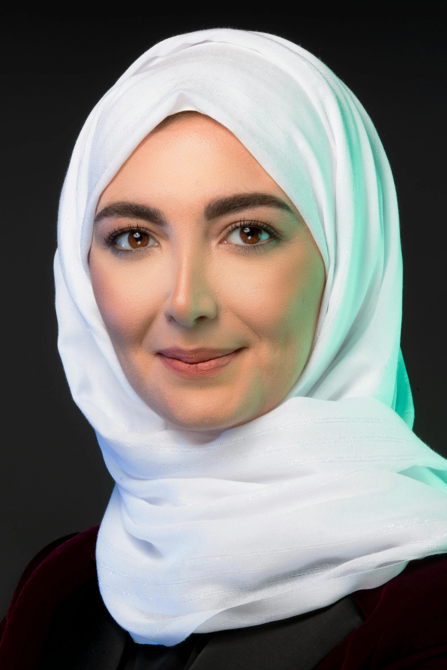 woman in a headscarf smiling for the camera