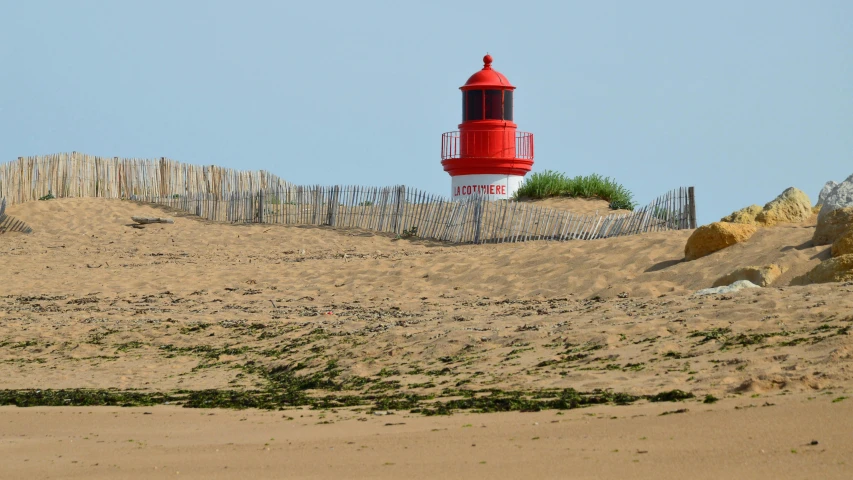 a light house on top of a sandy hill