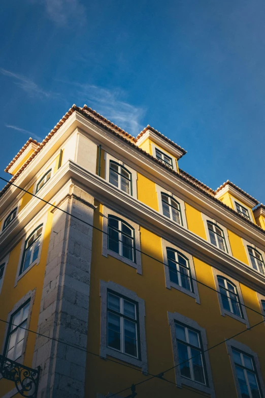 a yellow building with some windows on the side