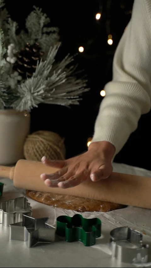 an image of someone rolling dough into a long rolling pin