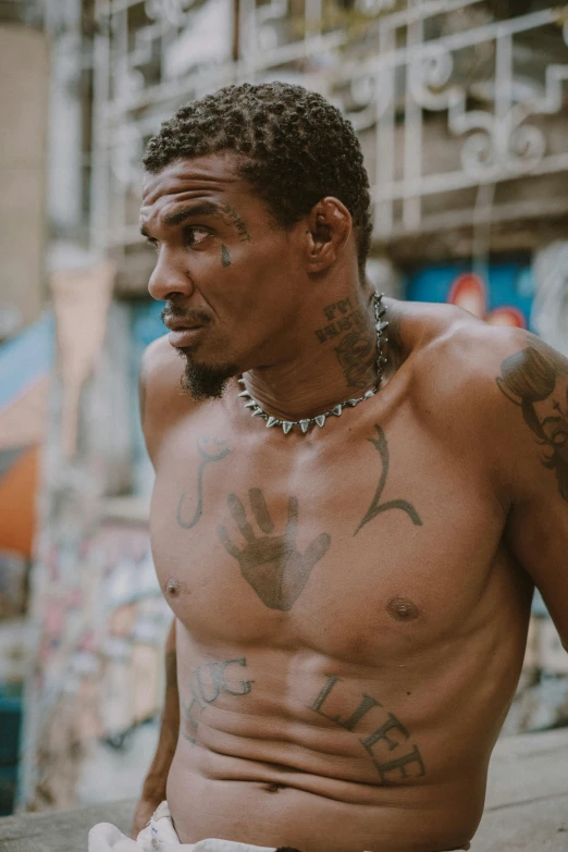 a man with several tattoos sitting down