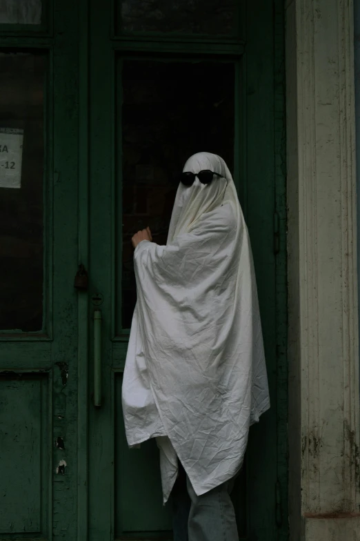 a person wearing a burka mask and sunglasses