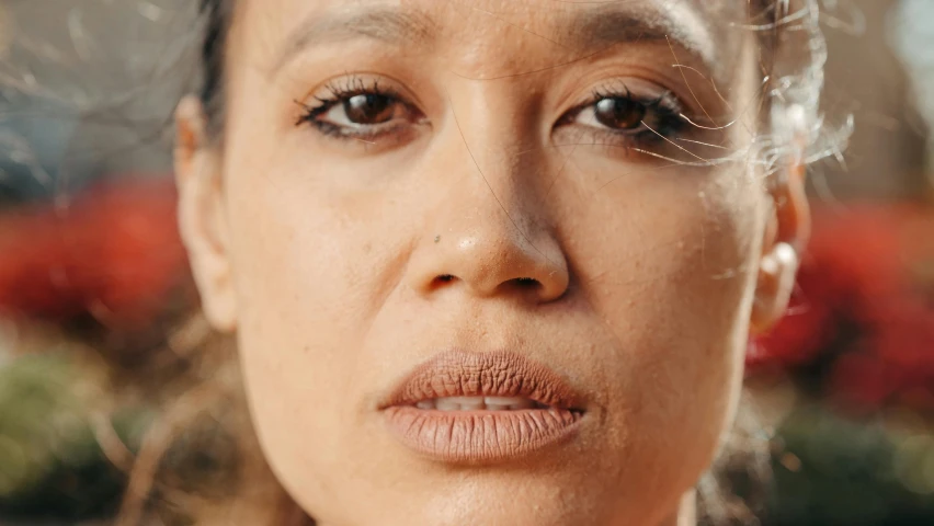 a close up of a female wearing earrings