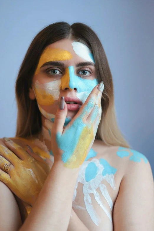 a woman with painted hands and face paints