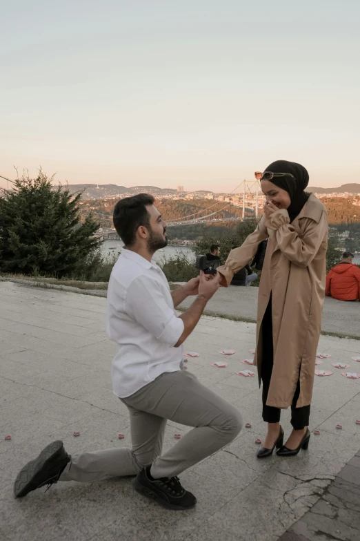 a woman touching a man's hand on the sidewalk