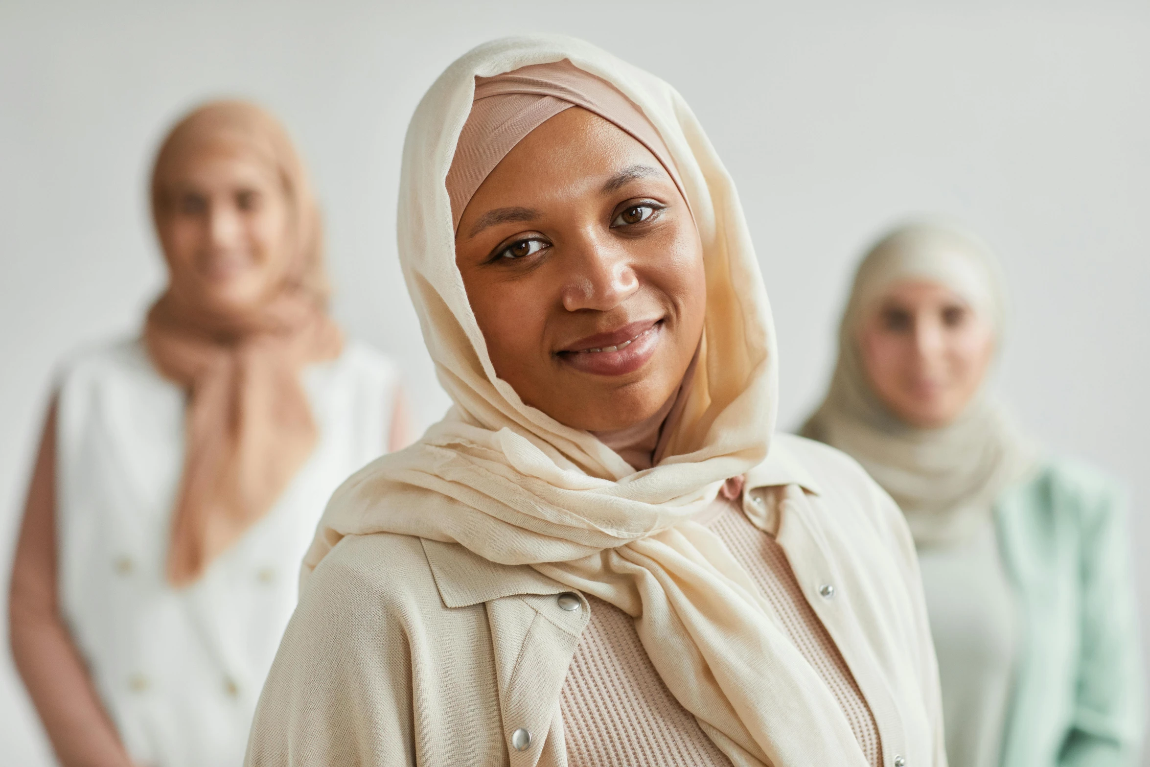 three woman wearing scarves and headscarves