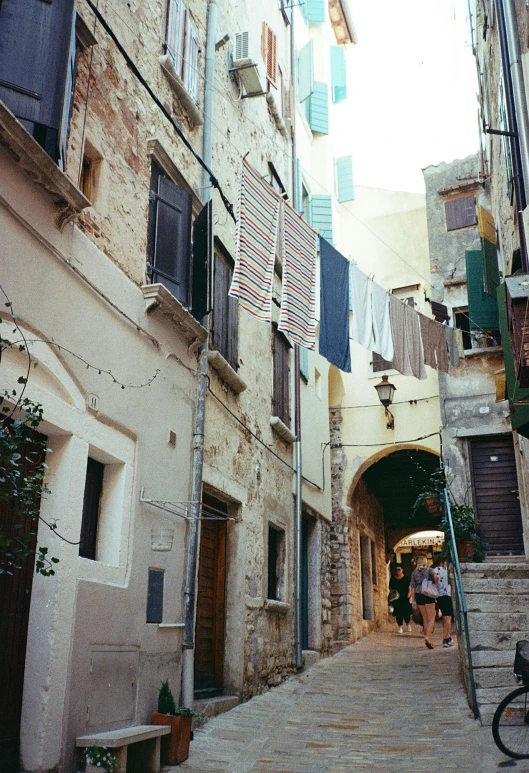 an alley way in a small city with buildings and a staircase