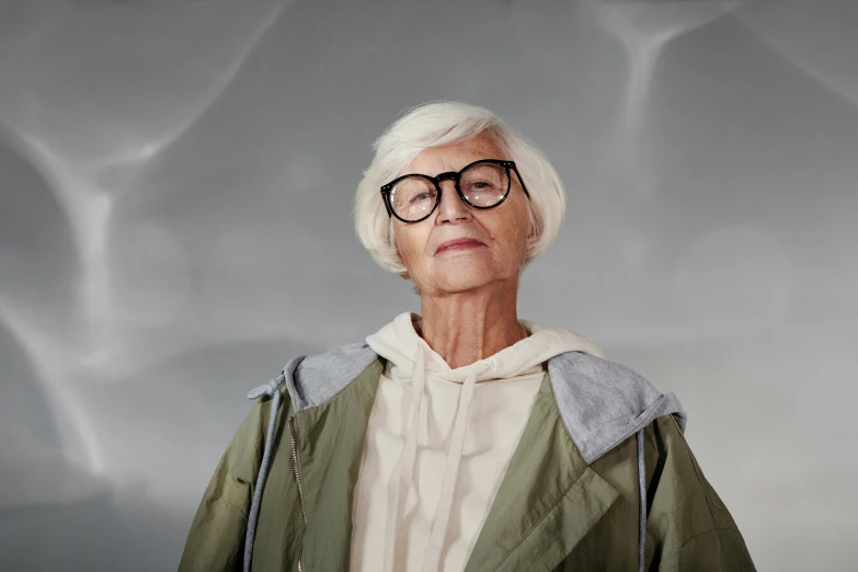 an old woman with glasses and green jacket