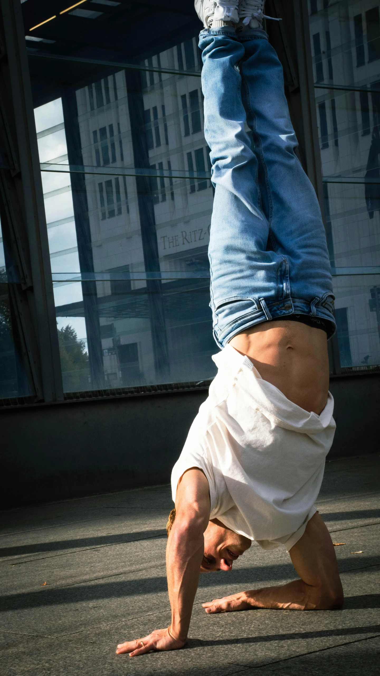 a person that is doing a handstand on a skateboard