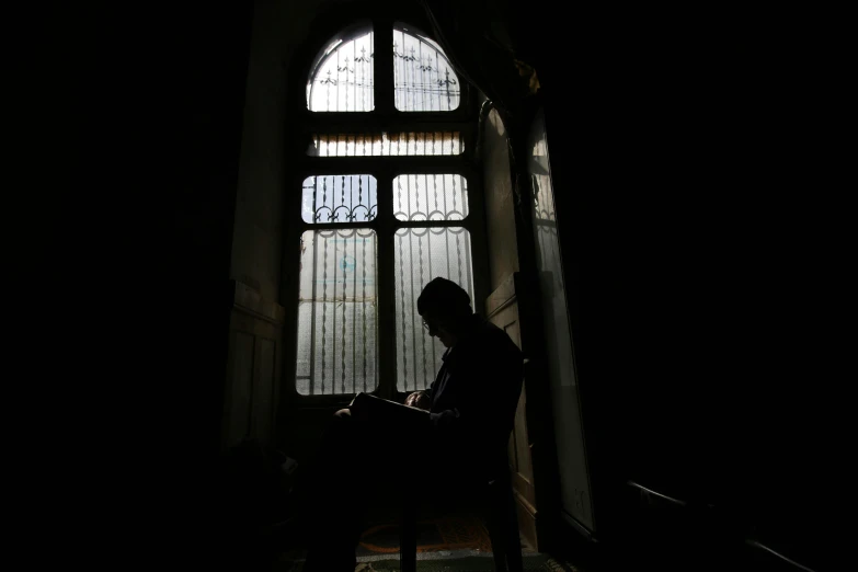 a person sits in front of an empty window