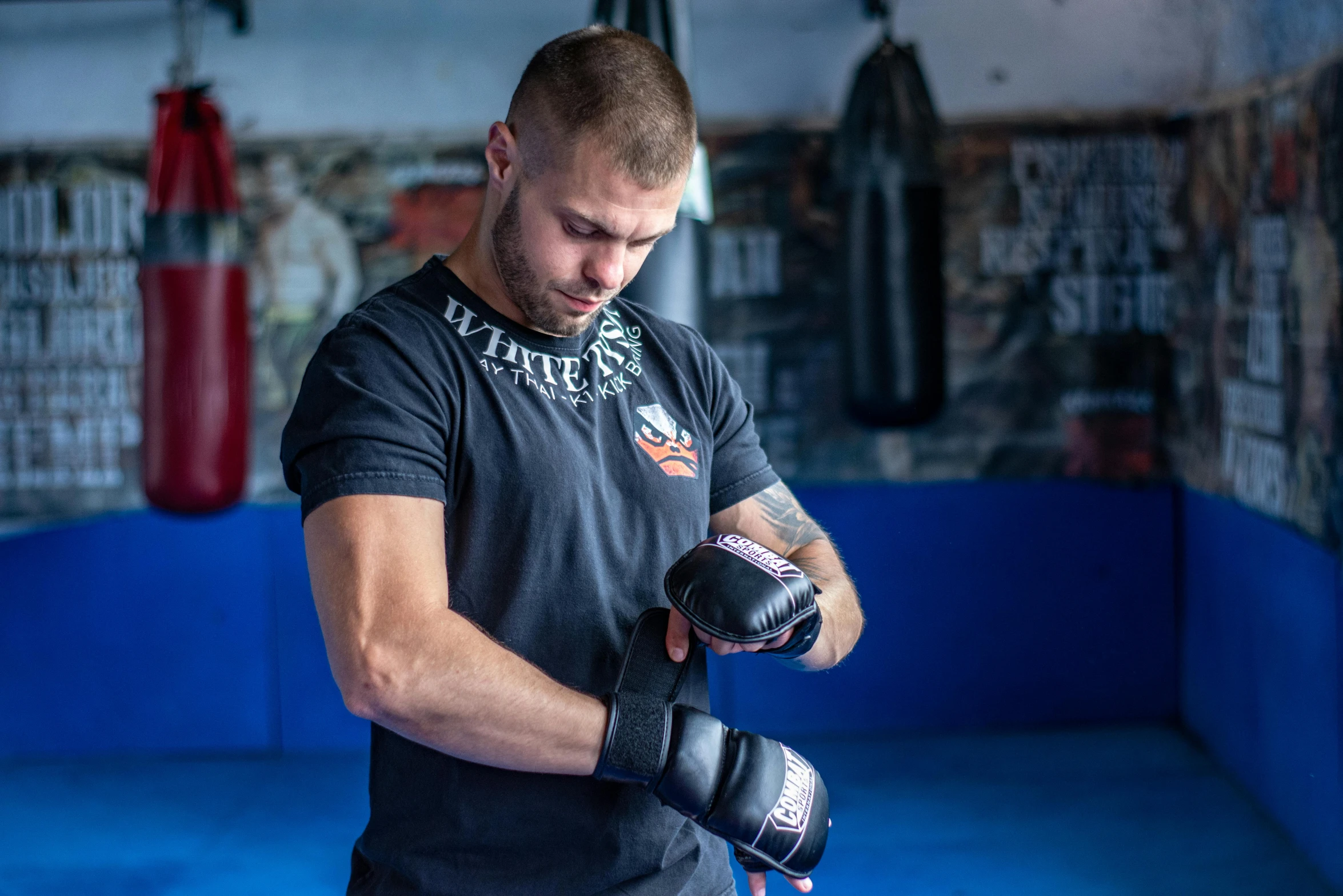 a man standing in a boxing ring with his punching gloves