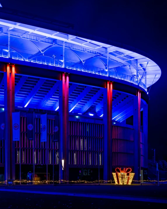 an arena sits in the middle of a large building at night