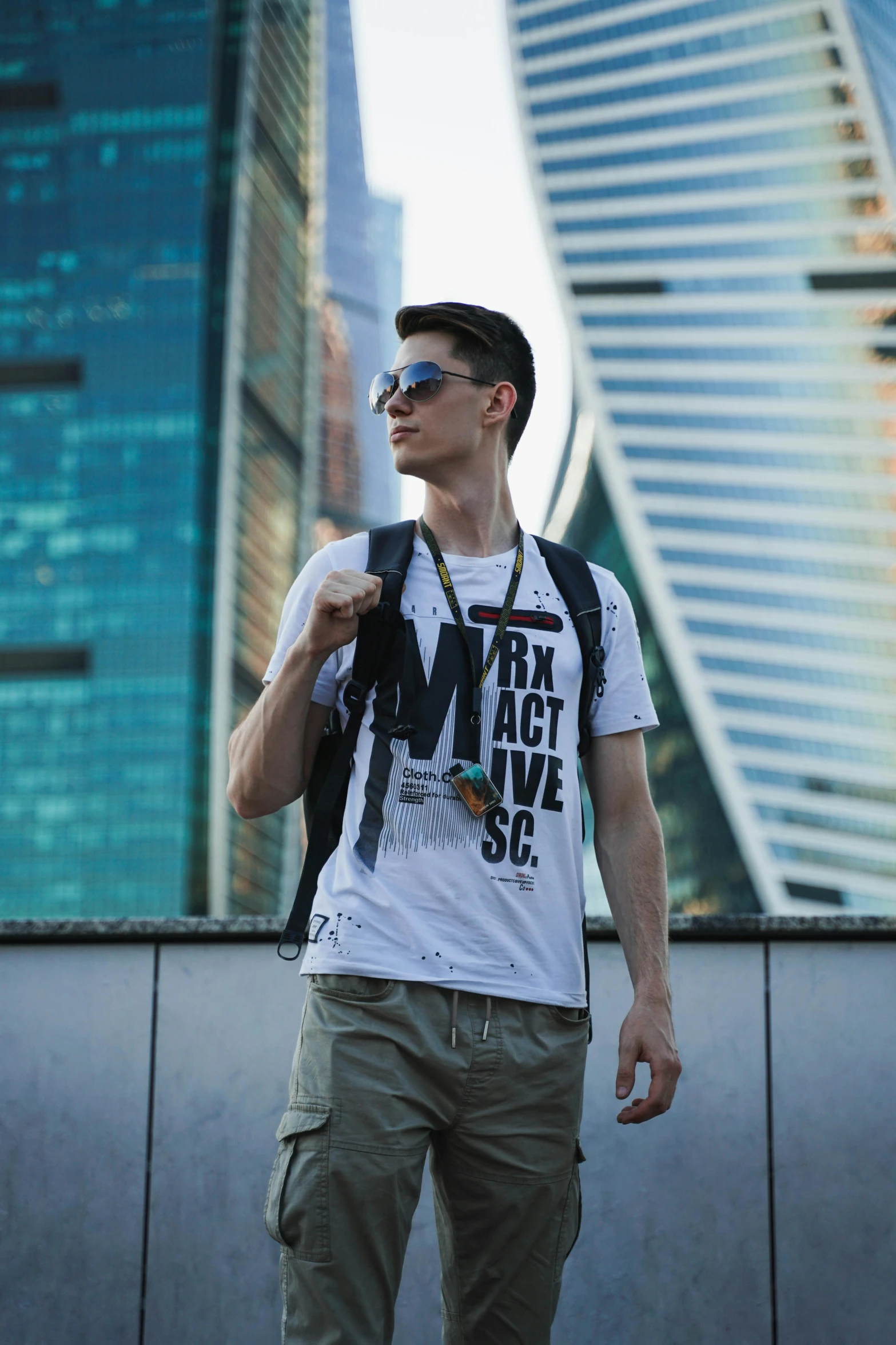 a man with his eyes closed is standing next to a building