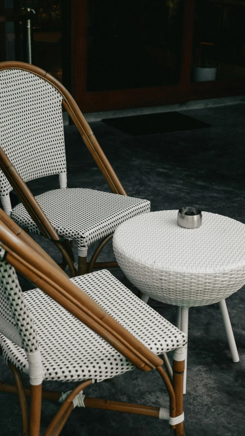 a set of wicker lounge chairs and table