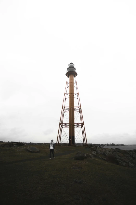 there is a man standing in front of a tower