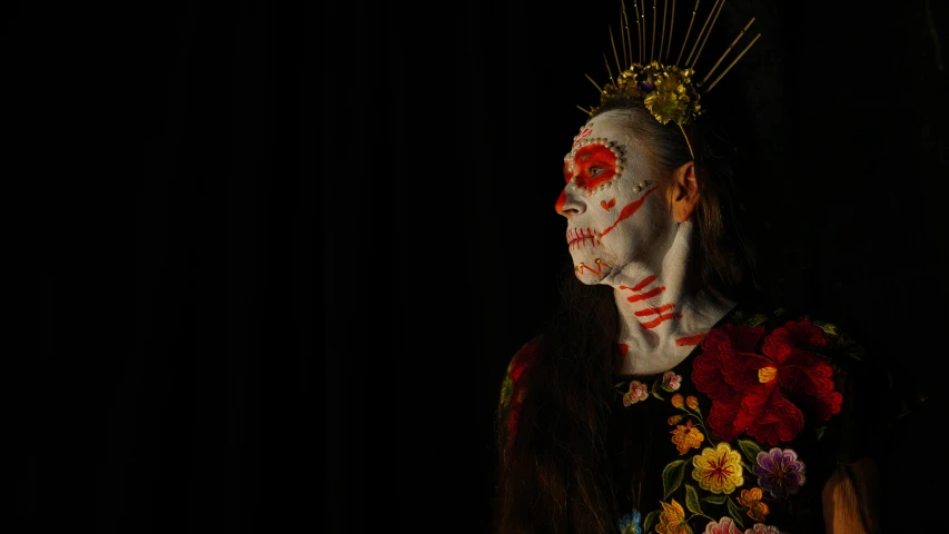 a woman with a make up and makeup standing in a dark room