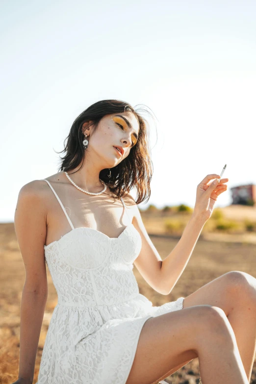 the girl sits on the ground with a cell phone