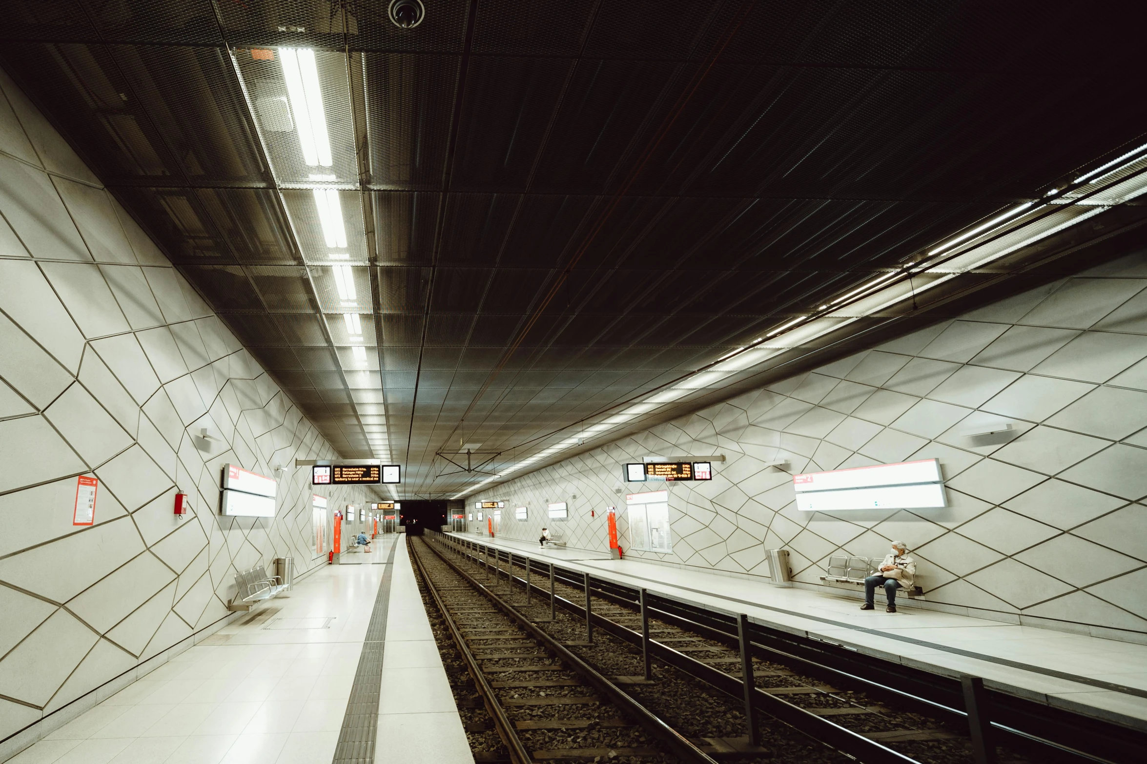 an underground train platform with people waiting for the subway