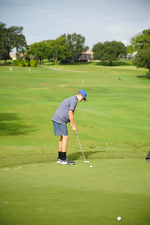 a man plays golf in the field