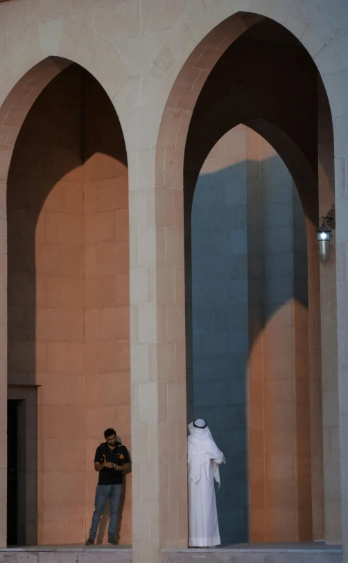 a man standing next to a statue in an outside museum