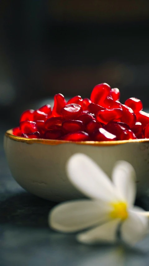 a small bowl full of jelly coated fruit