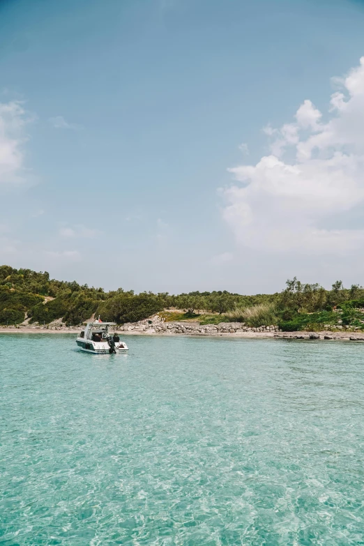 a small boat out in the water near the shore