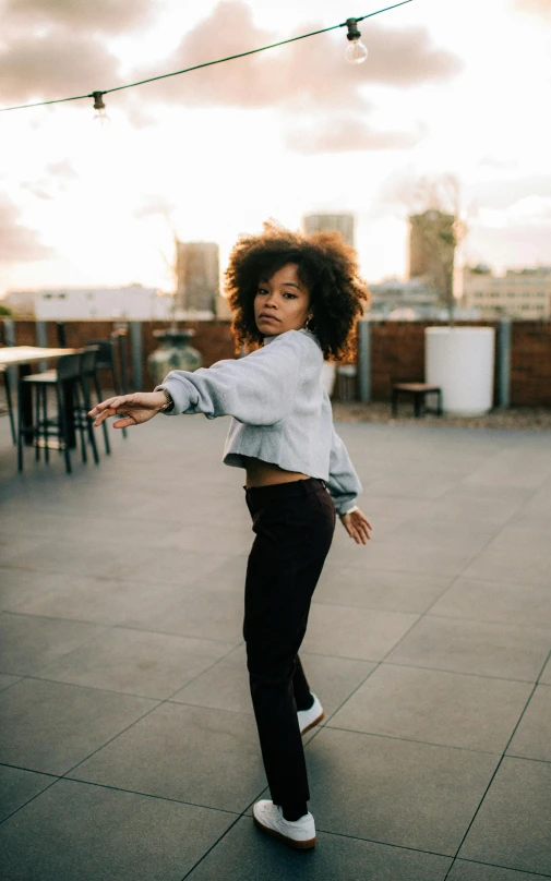 a woman riding a skateboard on top of cement floors