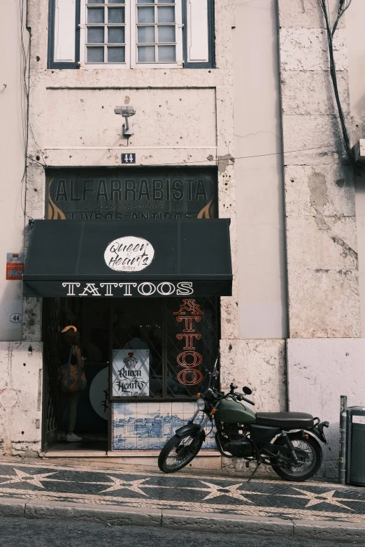 a motorcycle sits parked outside of a restaurant