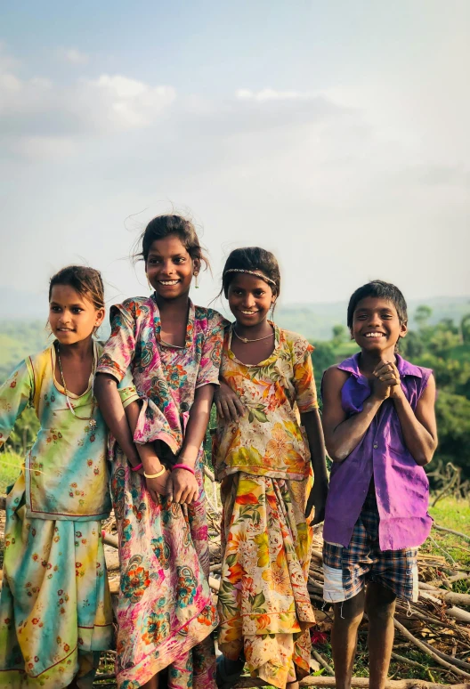 three little girls standing next to one another