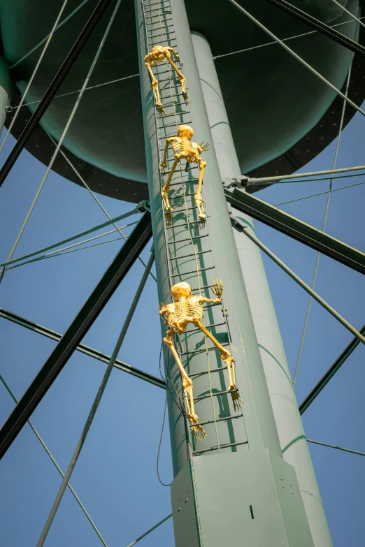 the yellow figures are on a tall pole