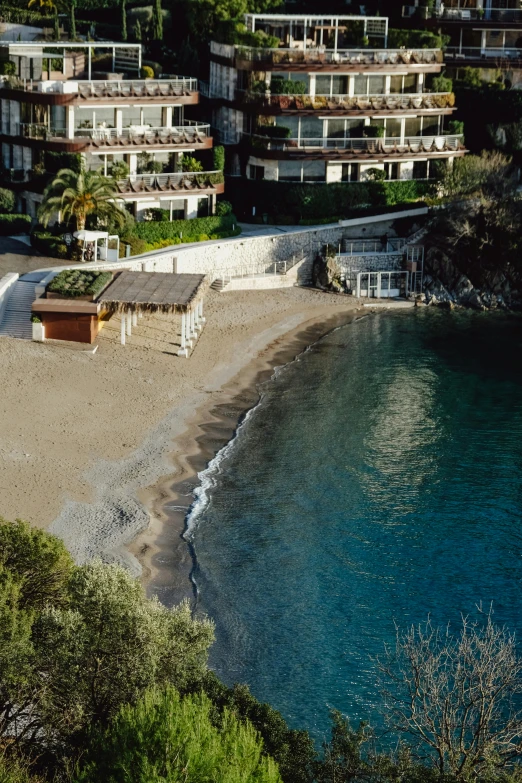 a beach scene with lots of houses next to the ocean