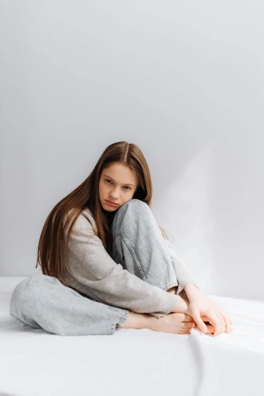 a woman is laying on her stomach in bed